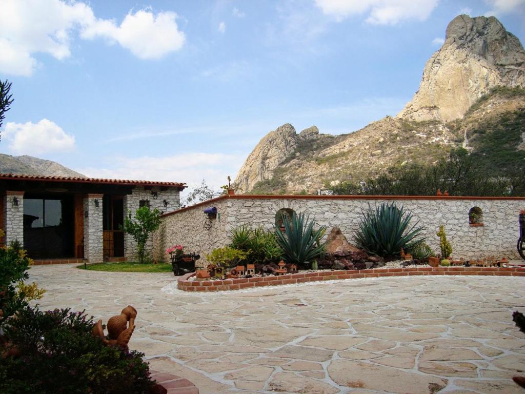 a house with a mountain in the background at El Cantar del Viento- Hotel Boutique in Bernal