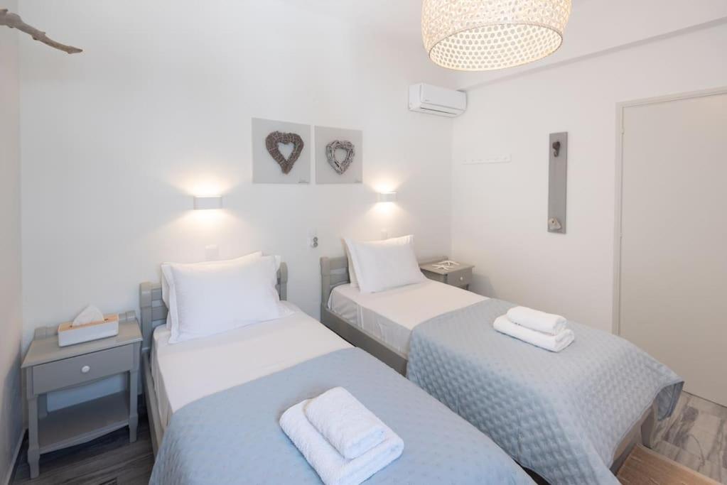 a room with two beds with towels on them at Swell S7 new 2 bd flat in Naousa in Naousa