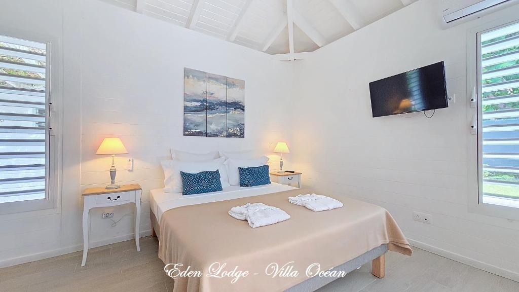 Postel nebo postele na pokoji v ubytování Eden Lodge 4 Villas avec piscine privée