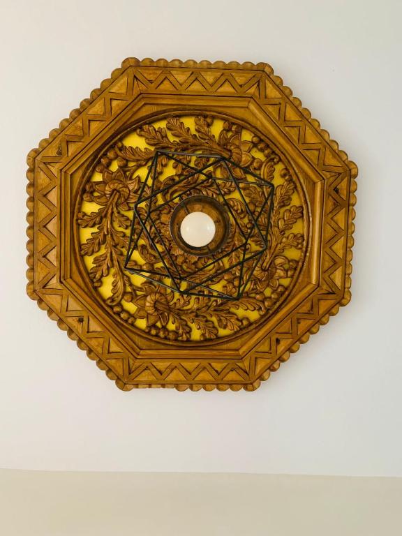 a gold plate on top of a ceiling at Vila Franko in Berat