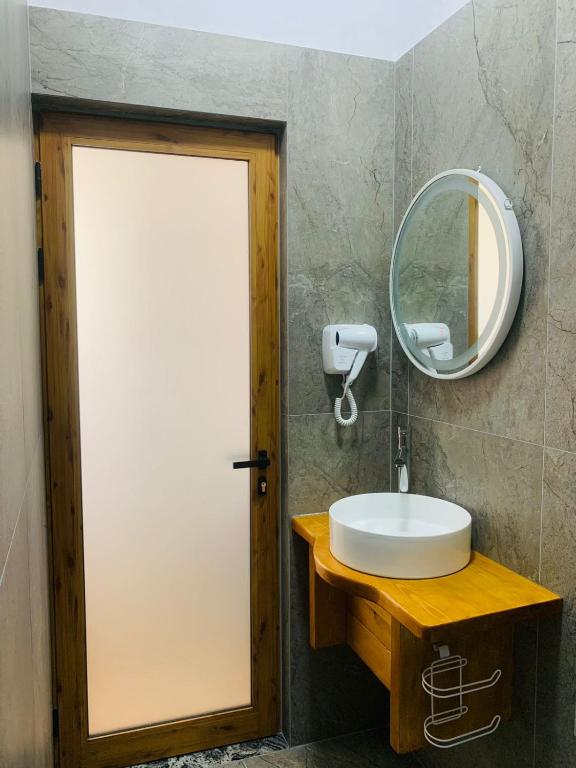 a bathroom with a white sink and a mirror at Vila Franko in Berat