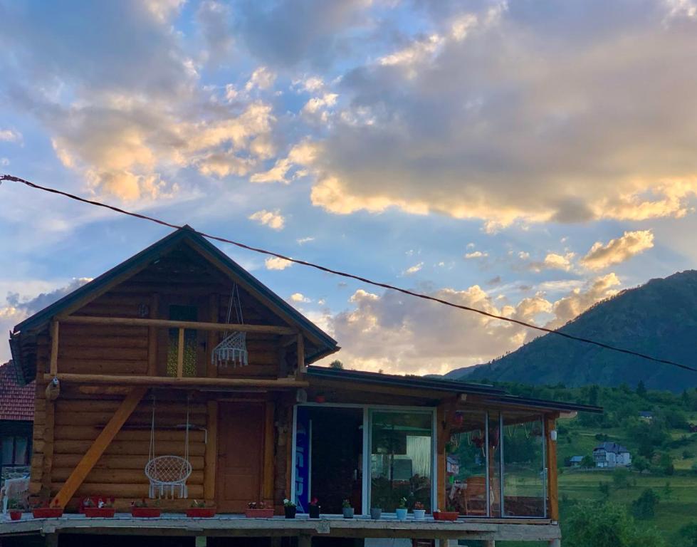 a log cabin with a sunset in the background at CAMP Odmaraliste PURISIC in Plav
