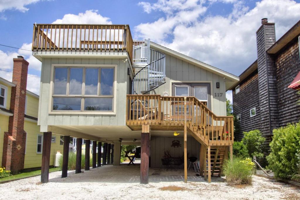 a house with a deck and a balcony at 117 Fourth St, Bethany Beach in Bethany Beach
