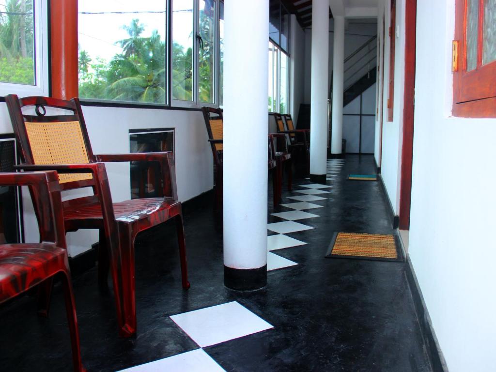 a hallway with chairs and tables in a building at Heaven Star Rest in Mirissa