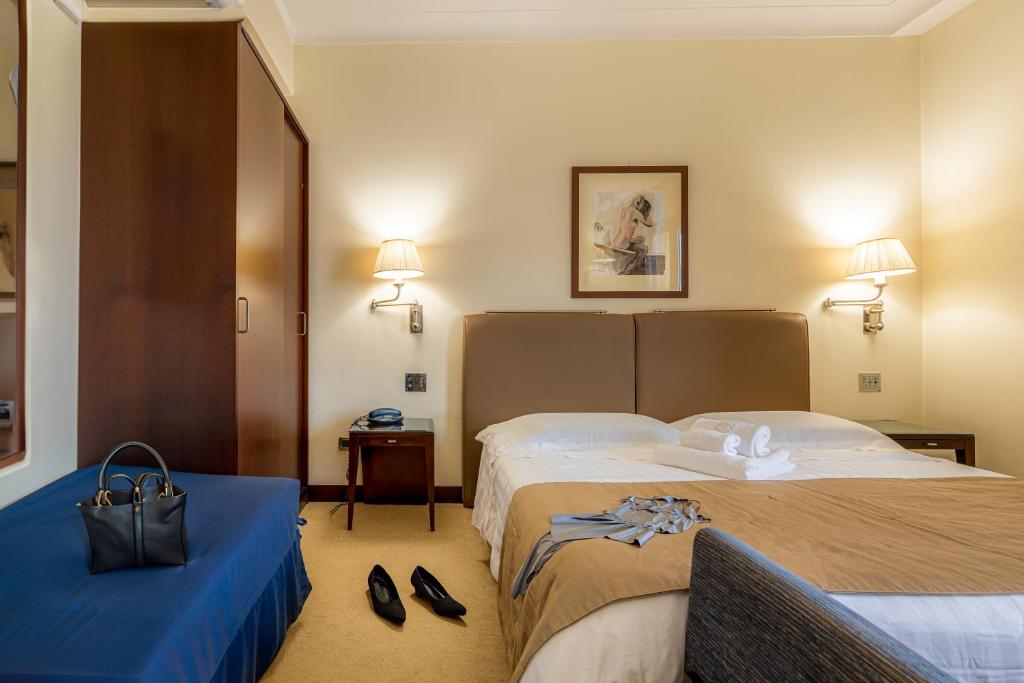 Posteľ alebo postele v izbe v ubytovaní Hotel Cala Del Porto