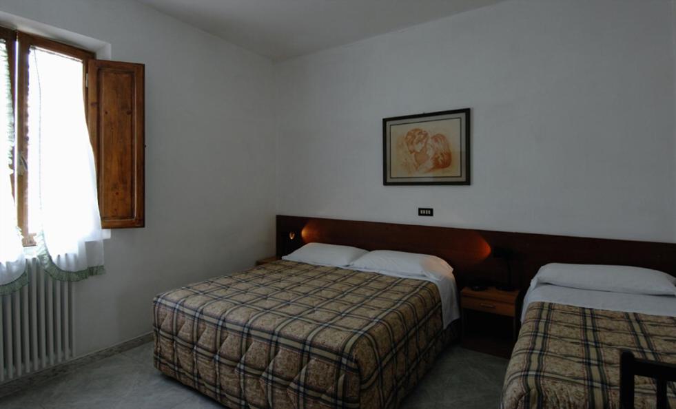 Кровать или кровати в номере Albergo Imperiale