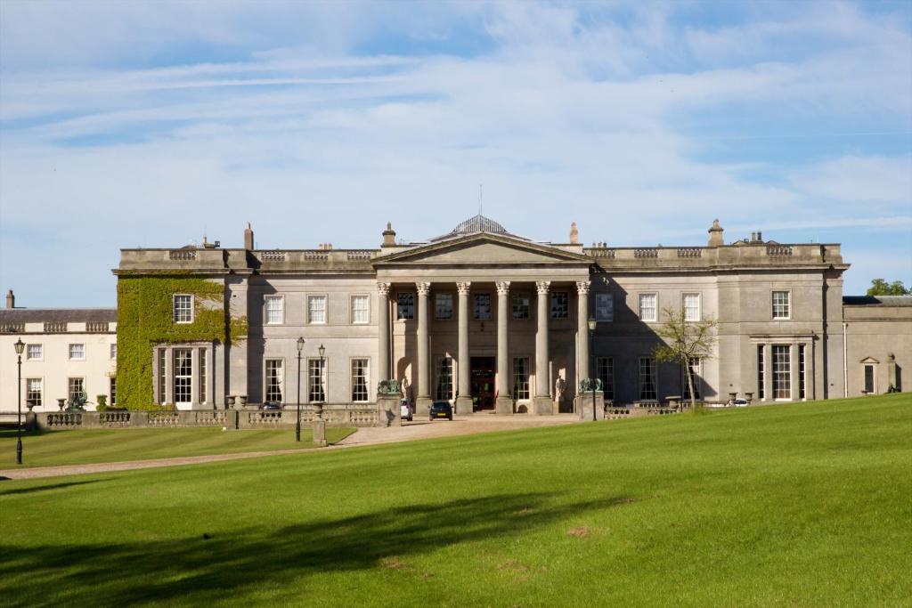 a large building with a grass field in front of it at Wynyard Hall Hotel & Spa in Billingham