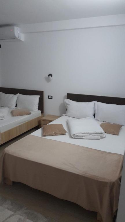 two beds sitting next to each other in a room at Black Sea in Costinesti