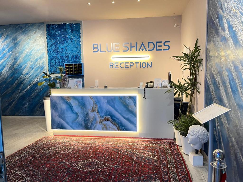a store with blue shades and a sign on the wall at Blue Shades Hotel in Pisa
