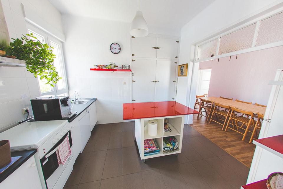 a kitchen with white counters and a red counter top at El Pez Escorpion in Salinas