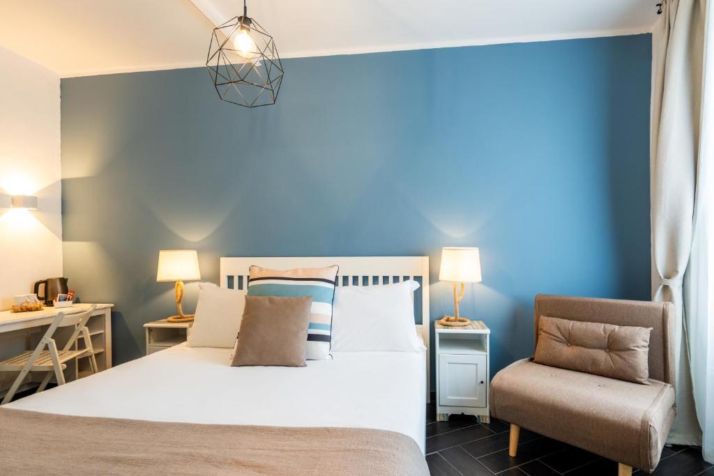 a bedroom with a bed and a chair at I Remi Del Prione by Le 5 Terre La Spezia in La Spezia