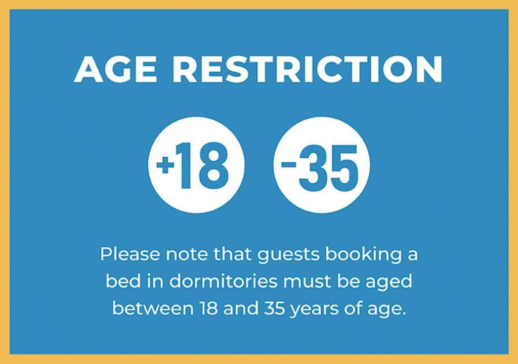 a sign that says age restriction and a bed in donations must be aged between at Hostel Castello Maggiore in Rome