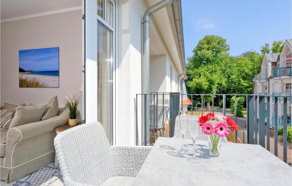 a balcony with a table with a vase of flowers on it at Baltischer Hof Apartment 23 in Boltenhagen