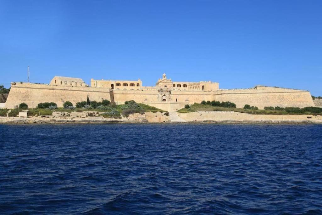a large building on an island in the water at NR Retreat in Il-Gżira