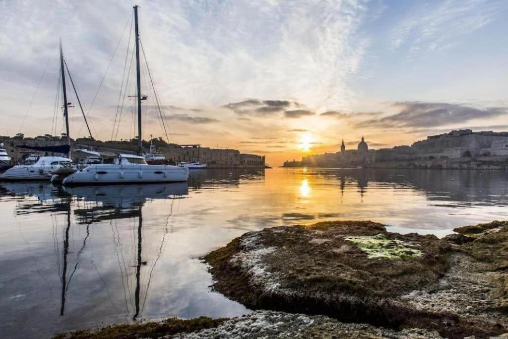 a group of boats docked in a harbor at sunset at NR Retreat in Il-Gżira