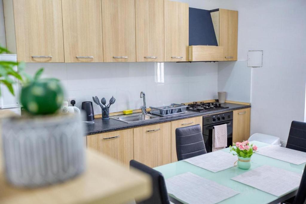 a kitchen with a sink and a table with chairs at NR Retreat in Il-Gżira