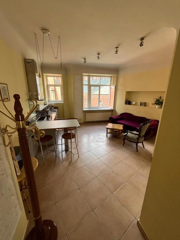 a kitchen and living room with a table and chairs at BestHomeRiga in Riga