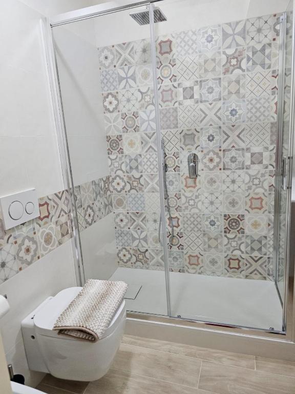 a bathroom with a shower and a toilet at Hotel Fernanda in Letojanni