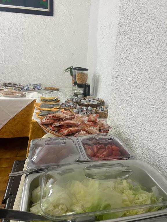 a buffet of food with meat and vegetables on a table at Hotel Fernanda in Letojanni