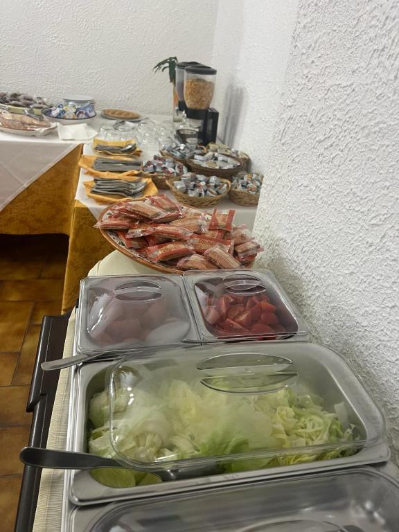 a buffet of food with meat and vegetables on a table at Hotel Fernanda in Letojanni
