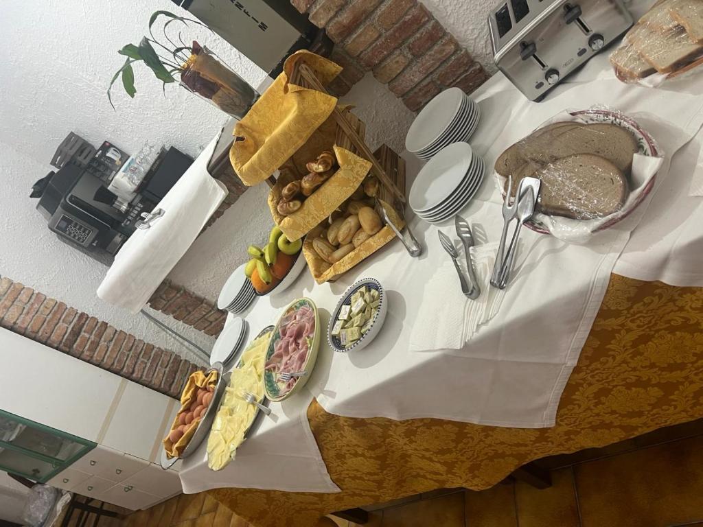 a table with plates of food on top of it at Hotel Fernanda in Letojanni