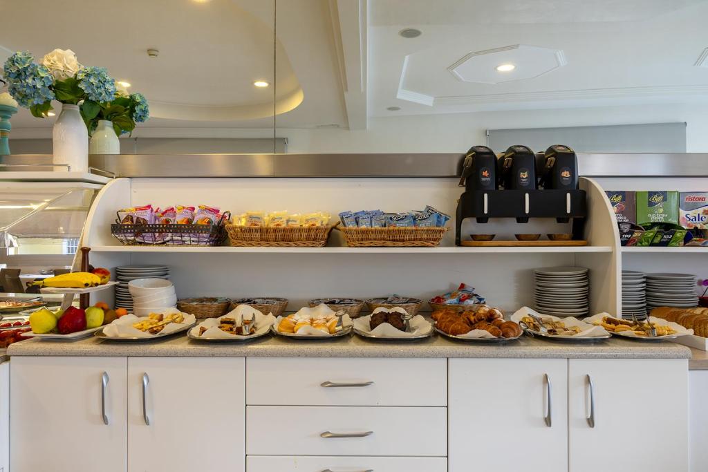 a kitchen with plates of food on a counter at Hotel Bristol in Caorle