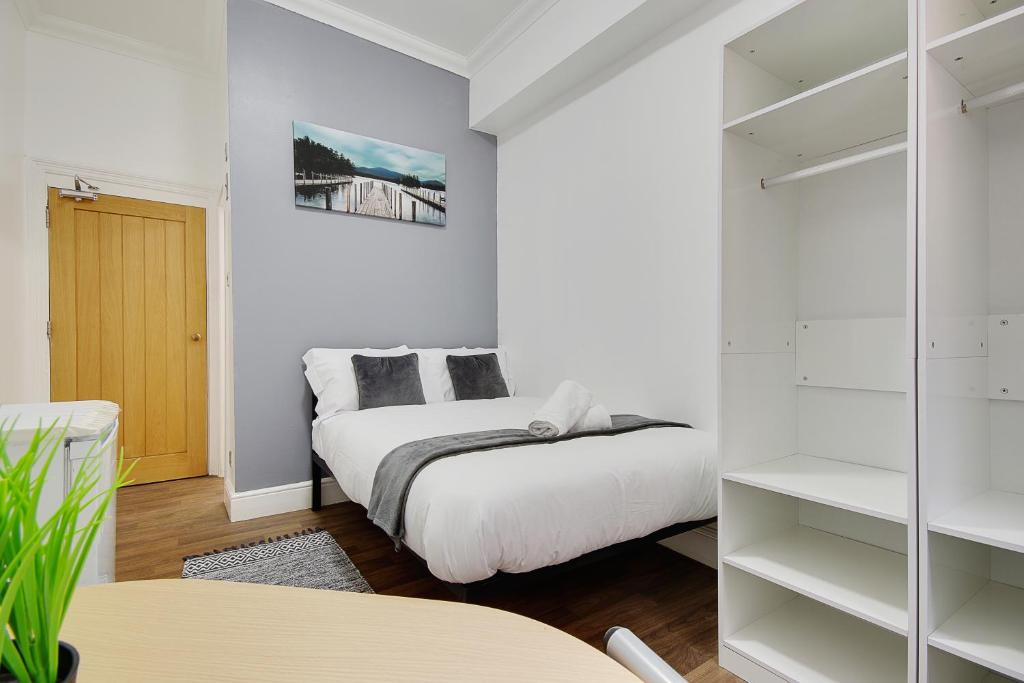 a bedroom with a bed and a closet at Bonnington Beach in Bournemouth