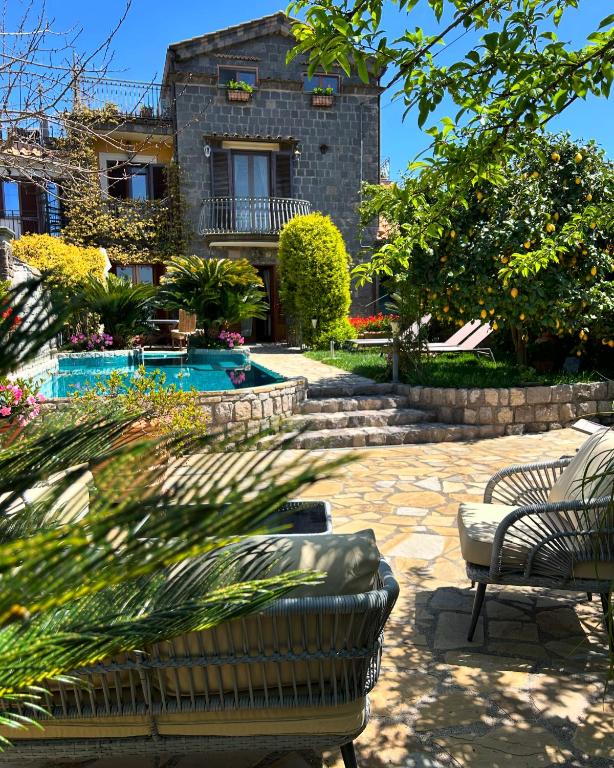 a house with a patio and a swimming pool at Maison Villa Angela in SantʼAgata sui Due Golfi