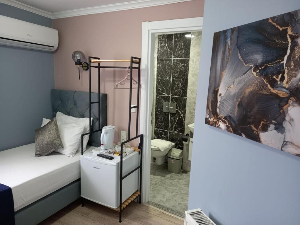 a bedroom with a bed and a bathroom with a shower at Emirhan Inn Hotel, Sultanahmet in Istanbul