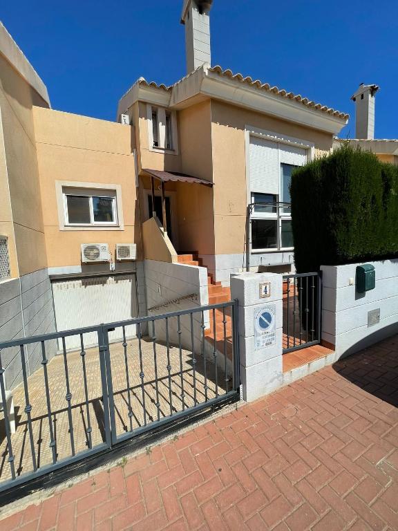 a house with a fence in front of it at Los Belones, Mar Menor España in Los Belones