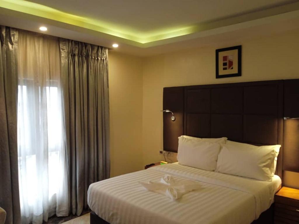 Postel nebo postele na pokoji v ubytování Mulligan Hotel