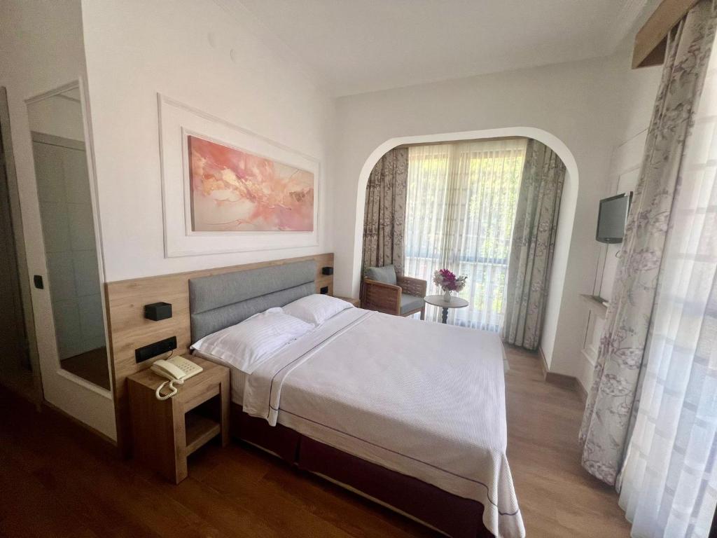 Postel nebo postele na pokoji v ubytování Carikci Hotel