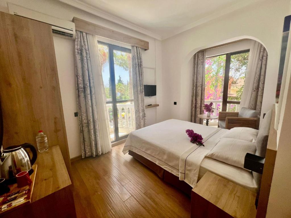 Postel nebo postele na pokoji v ubytování Carikci Hotel