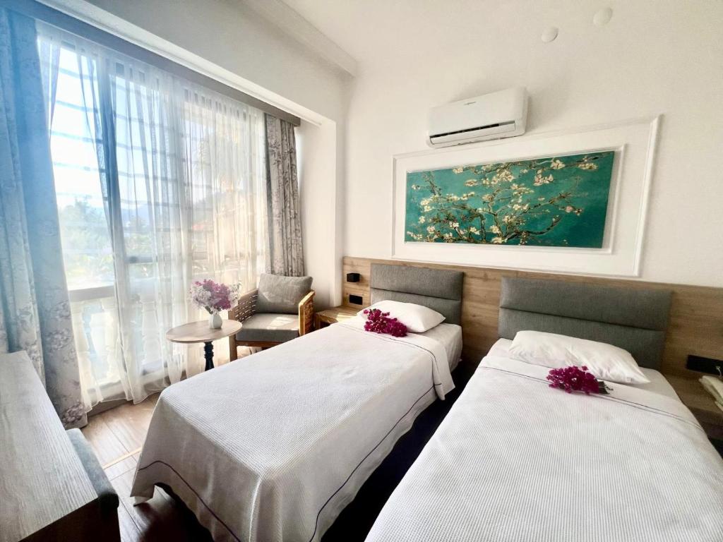 Postel nebo postele na pokoji v ubytování Carikci Hotel