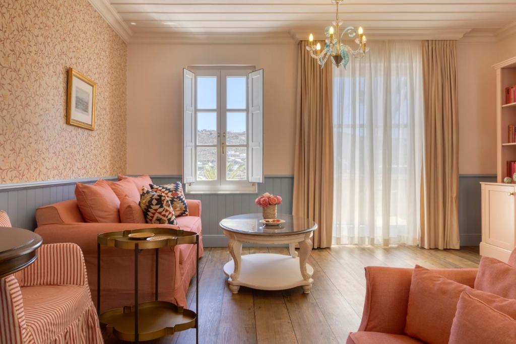 a living room with a couch and a table at Dorion Hotel in Ornos