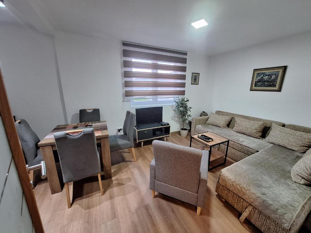 a living room with a couch and a table at Neda Guesthouse in Žabljak
