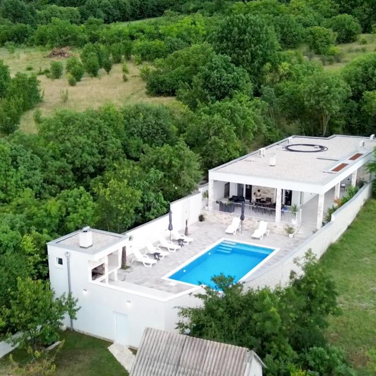 an aerial view of a house with a swimming pool at Villa Blanco in Mostar