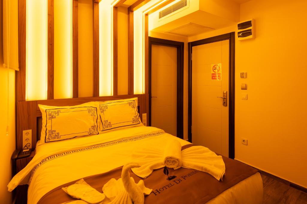 a bedroom with a large bed with yellow walls at hotel di poesia deluxe in Istanbul