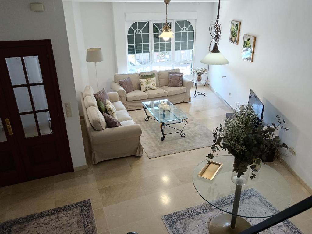 a living room with two couches and a glass table at Casa Beatriz in Cambados