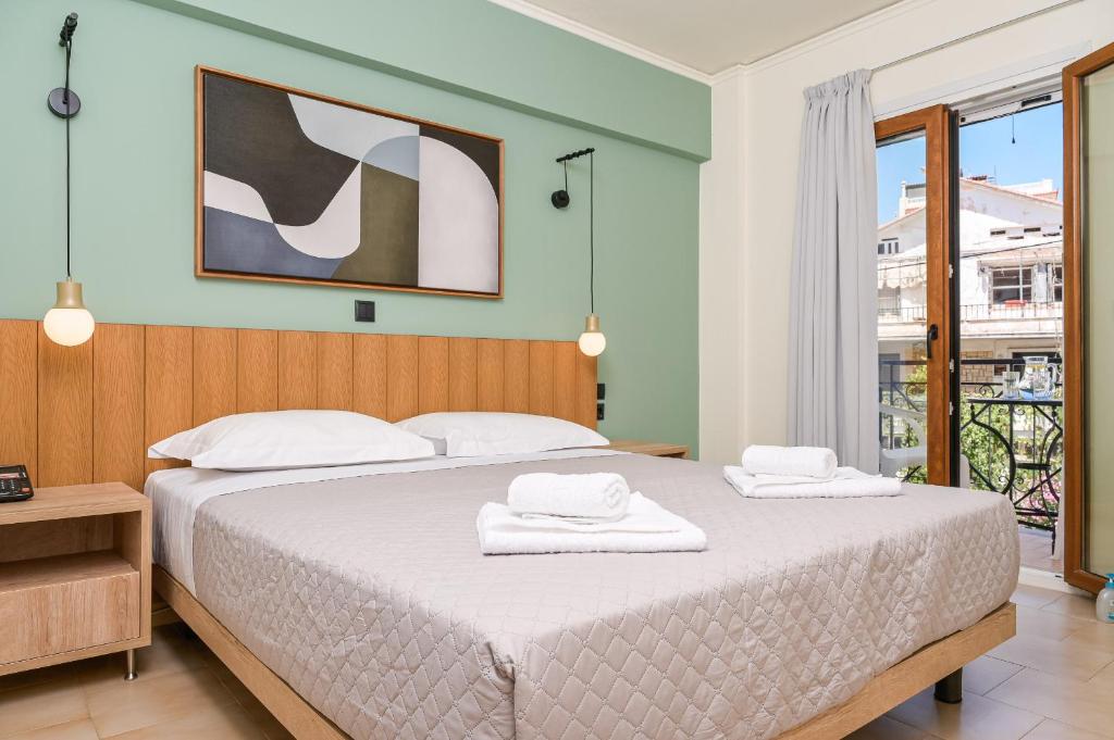 A bed or beds in a room at Emily Hotel