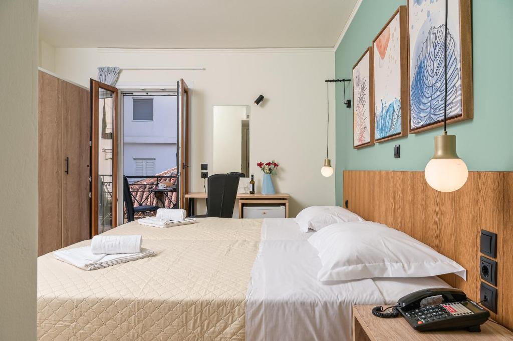 A bed or beds in a room at Emily Hotel
