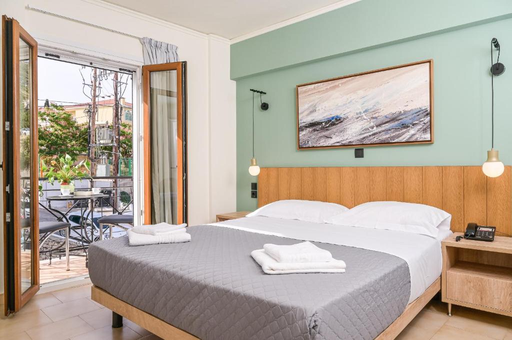 A bed or beds in a room at Emily Hotel