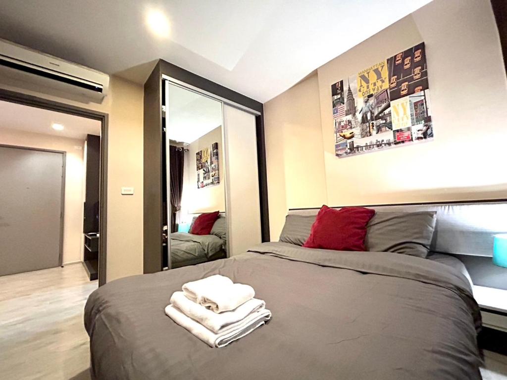 a bedroom with a bed with towels on it at The Base Central Pattaya Super condo in Pattaya Central
