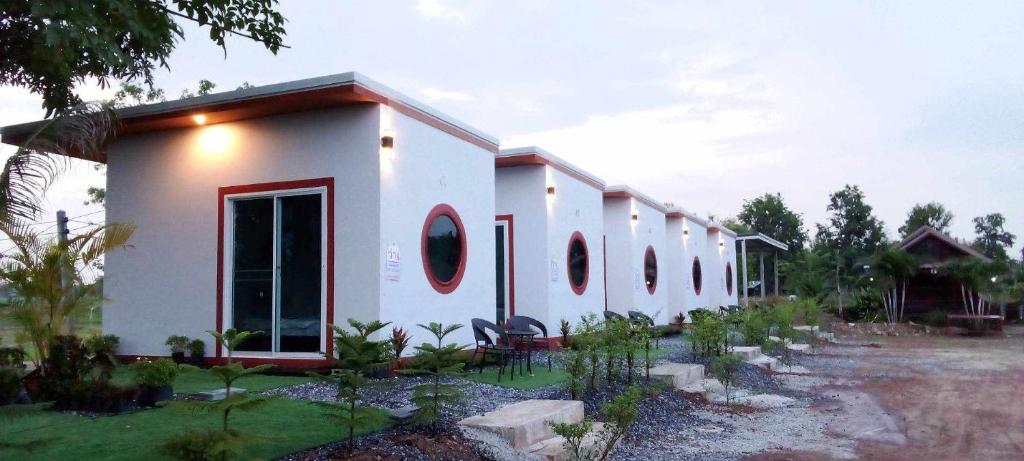 een wit gebouw met ronde ramen bij จันทร์ทิพย์คคำชะโนด 2 เฟท 2 in Ban Dung