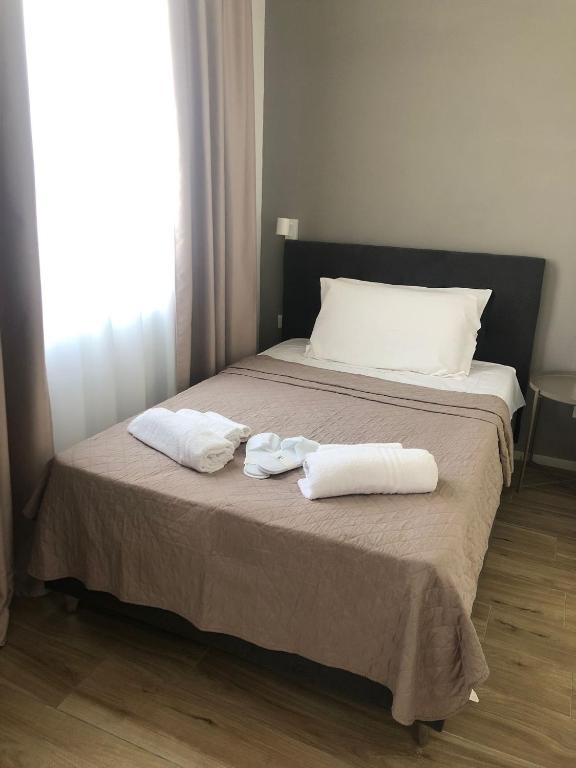 Łóżko lub łóżka w pokoju w obiekcie SOMA