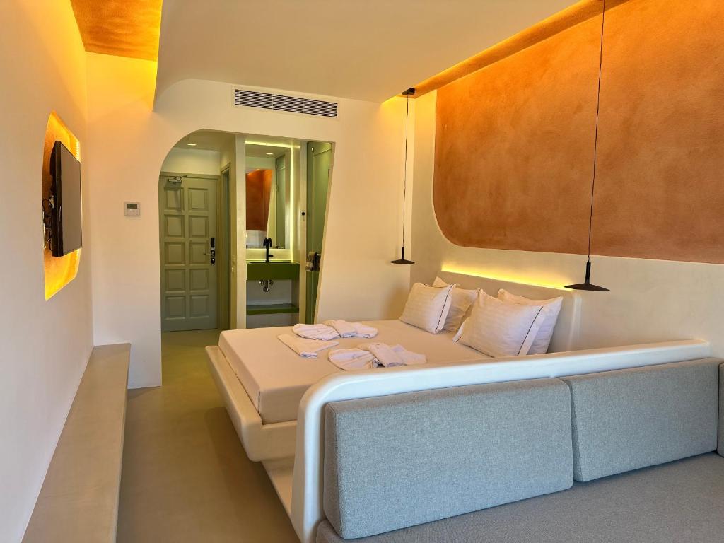 a bedroom with a bed with two towels on it at Yperia Hotel in Aegiali