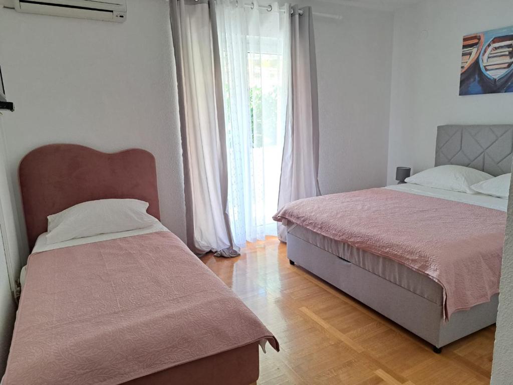 Postel nebo postele na pokoji v ubytování Apartments Tily