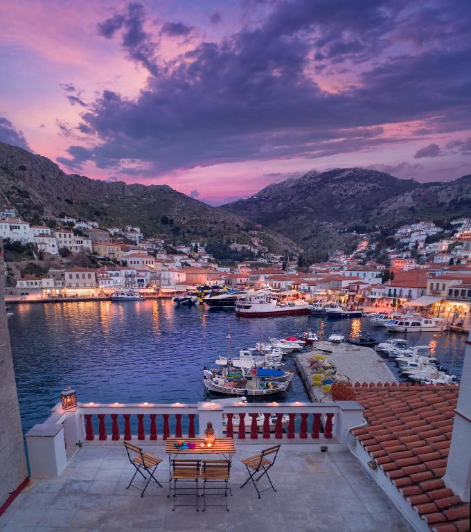 a view of a marina with a table and chairs at Douskos Exclusive Property in Hydra