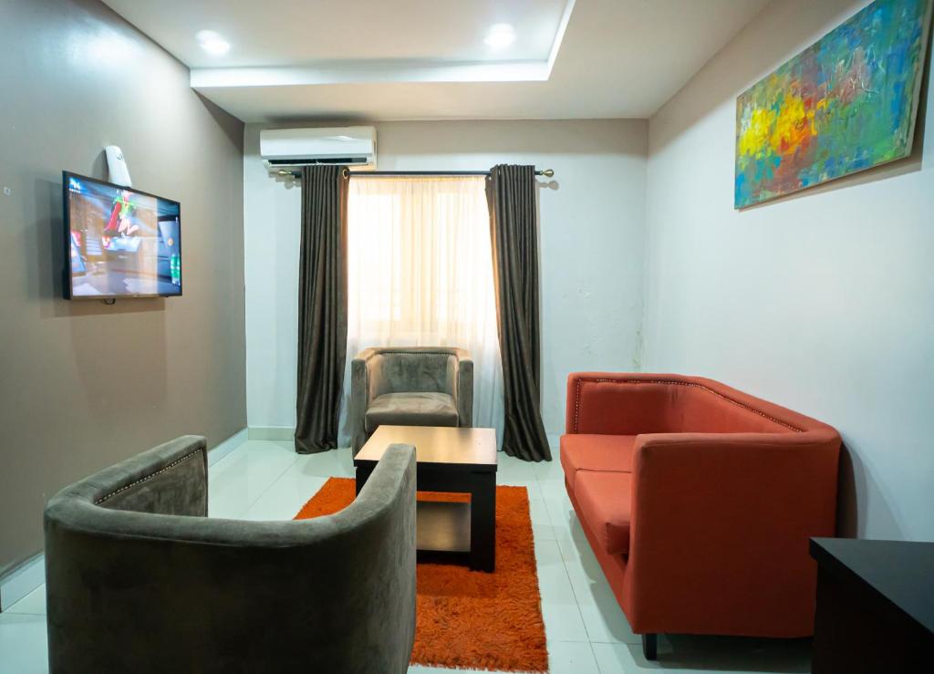 a living room with two chairs and a table at The Lodge-Stack By Kabachi in Lagos