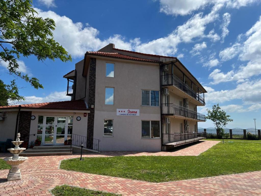 a building with a lawn in front of it at IOANA - camere de inchiriat in Mangalia